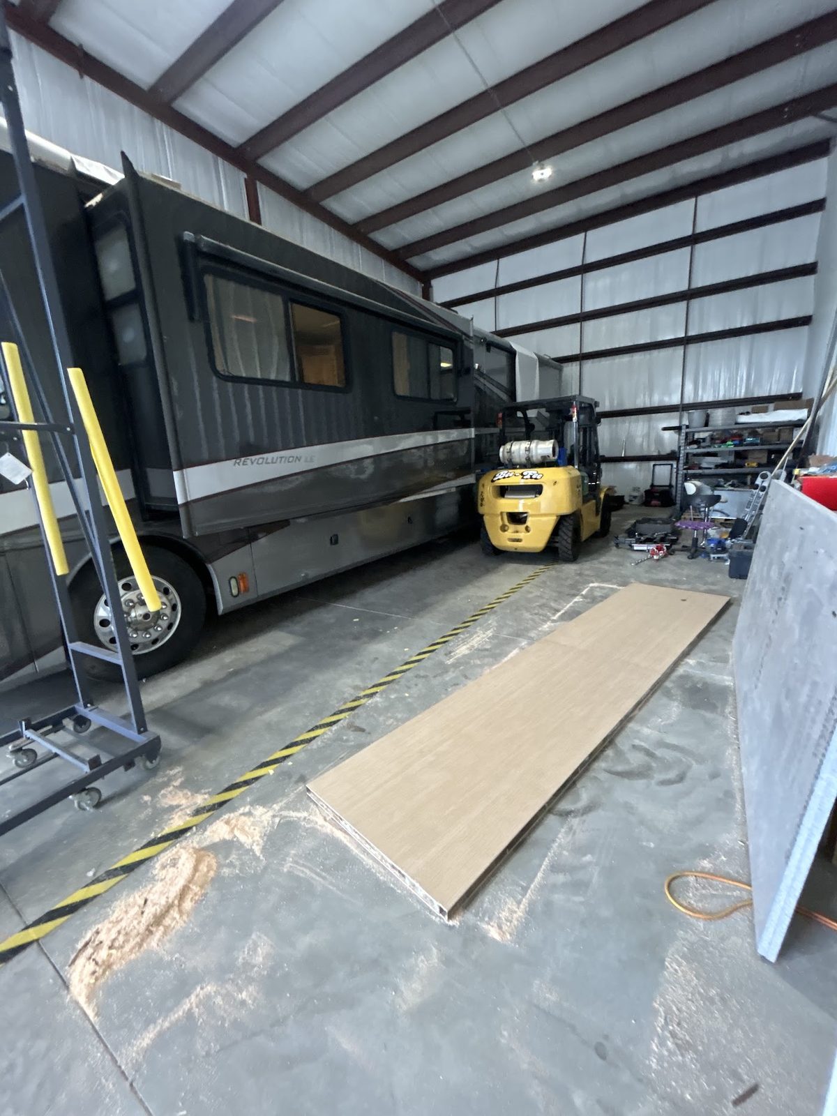 Class A diesel pusher in the repair bay during slide-out floor work