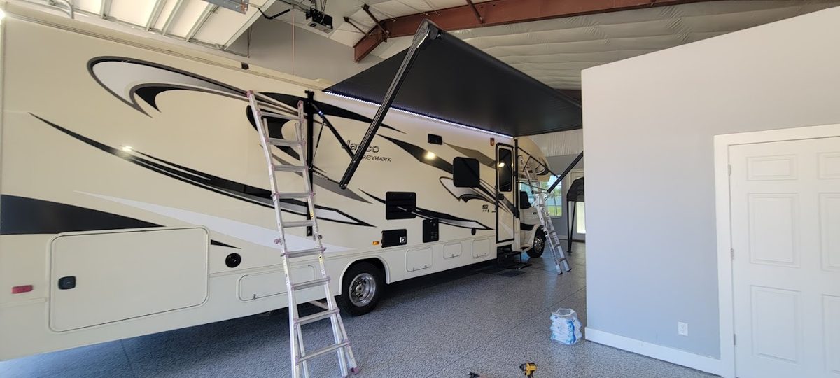 Class C motorhome inside the Plant City shop during an awning installation